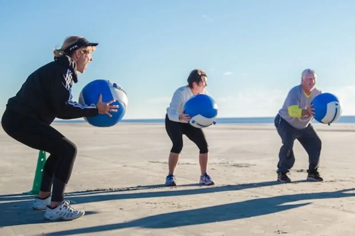 A small group training session with medicine balls on the beach
